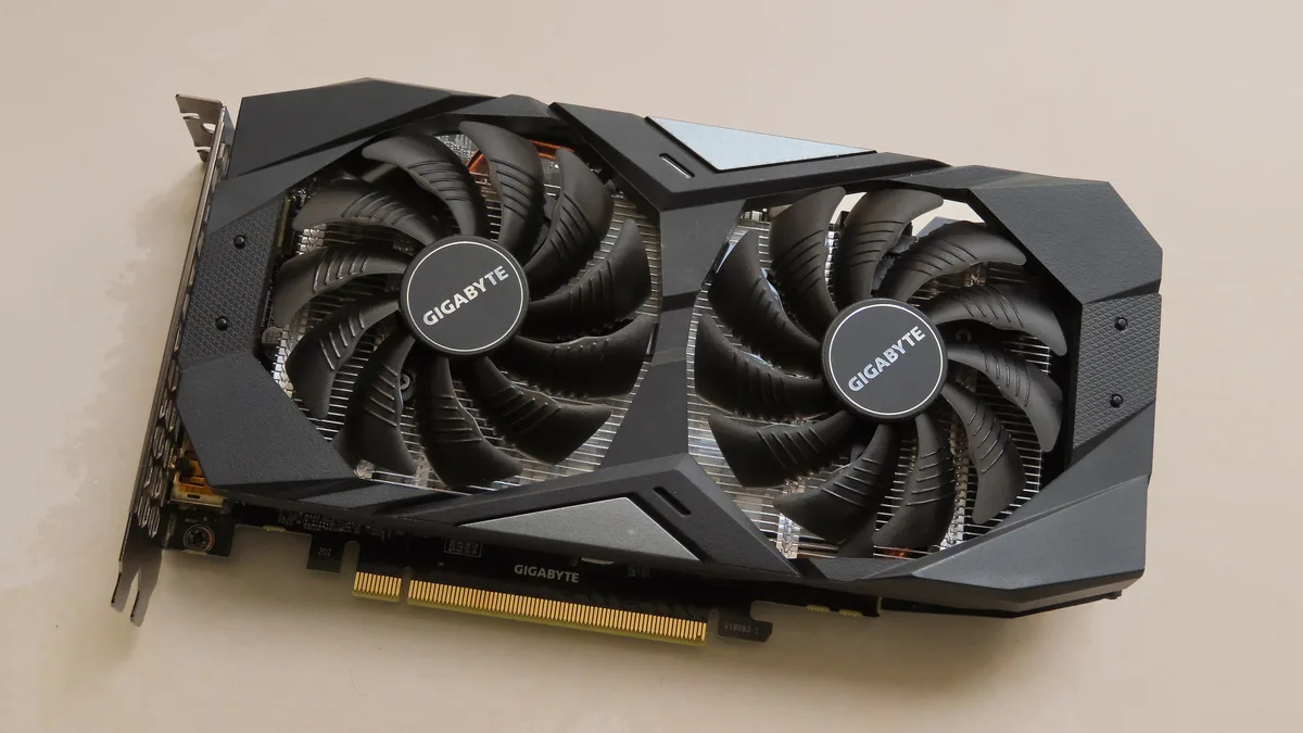 A dual-fan Gigabyte GeForce GTX 1660 Ti graphics card, the class of card a $150 budget buys used in 2026